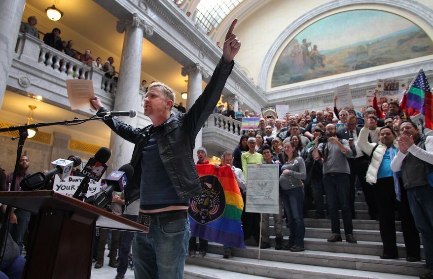 FILE - In this Friday, Jan. 10, 2014, file photo, Troy Williams, a local LGBT organizer, speaks to a crowd of supporters of gay marriage as they gathered to rally and deliver more than 58,000 petition signatures in support of gay marriage to Utah Gov. Gary Herbert at the Utah State Capitol in Salt Lake City. In less than a month, two federal judges have struck down state bans on gay marriage for the same reason, concluding that they violate the Constitution’s promise of equal treatment under the law. Although that idea has been the heart of the gay marriage debate for years, the decisions in deeply conservative Oklahoma and Utah offer new momentum for litigants pressing the same argument in dozens of other cases across the country. (AP Photo/Steve C. Wilson, File)
