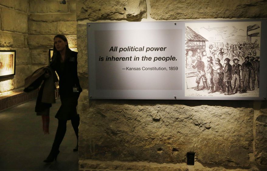 A quote from the Kansas Constitution hangs in the newly renovated gallery at the Statehouse in Topeka, Kan., Wednesday, Jan. 15, 2014. Gov. Brownback waxed nostalgic Wednesday in his prepared statement, noting new displays in the renovated Statehouse proclaim a line from the Kansas Constitution that "all political power is inherent to the people." (AP Photo/Orlin Wagner)