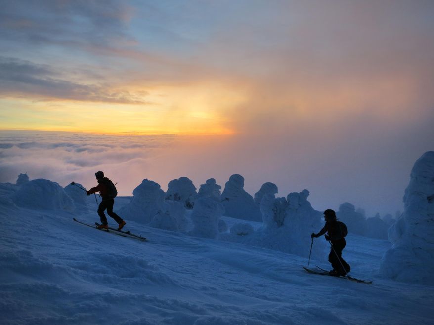 In this Jan. 15, 2013 photo, Jeff Zickler and Daniel Henry ascend to the summit of Mount Spokane at dawn in Spokane, Wash. Mt. Spokane Ski and Snowboard Park is going through a public comment process to draw up rules and perhaps set fees for uphill travel within the downhill skiing concession area it leases from Mount Spokane State Park. (AP Photo/The Spokesman-Review, Travis Nichols) COEUR D'ALENE PRESS OUT