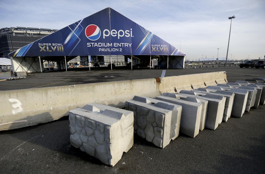 This photo shows concrete barricades in the parking lot of MetLife Stadium as crews prepare the grounds ahead of Super Bowl XLVIII, Wednesday, Jan. 15, 2014, in East Rutherford, N.J. Police officials say security for the Super Bowl will include about 4,000 government and private officers assigned to the stadium on game day. Fans arriving at the game by mass transit on Feb. 2 will encounter a security perimeter extending 300 feet from entrances to the stadium. They'll be funneled into temporary pavilions for airport-style screening. (AP Photo/Julio Cortez)