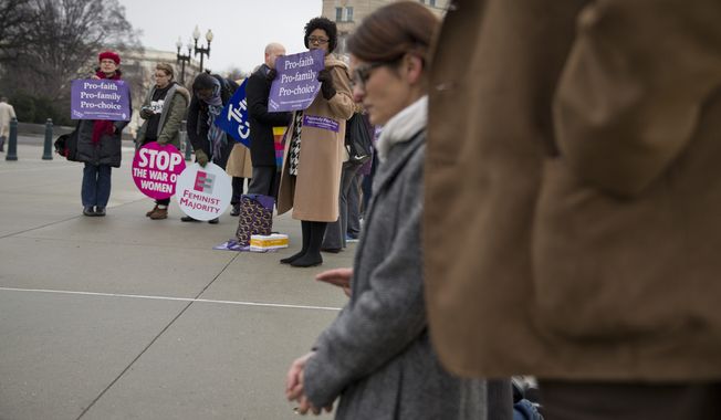 Pro-choice demonstrators (left) watch as a group of anti-abortion demonstrators pray on the steps of the Supreme Court when the court heard arguments about a protest-free zone outside Massachusetts abortion clinics. The high court struck down the law in 2014. (Associated Press)