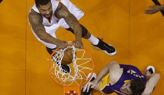 Phoenix Suns forward Markieff Morris dunks against Los Angeles Lakers forward Ryan Kelly during an NBA basketball game Wednesday, Jan. 15, 2014, in Phoenix. (AP Photo/The Arizona Republic, Michael Chow) MESA OUT  MARICOPA COUNTY OUT  MAGS OUT