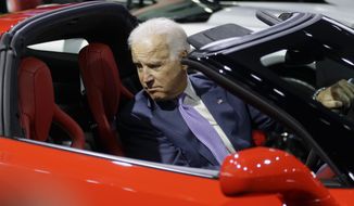 Vice President Joe Biden sits in a Corvette Stingray during a tour of the North American International Auto in Detroit, Thursday, Jan. 16, 2014. Biden said the U.S. auto industry&#39;s resurgence since the 2009 federal bailout provides a strong basis for a Motor City recovery.  (AP Photo/Carlos Osorio)