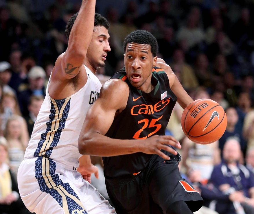 Miami guard Garrius Adams (25) drives against the defense of Georgia Tech guard Chris Bolden in the first half of an NCAA college basketball game, Saturday, Jan. 18, 2014, in Atlanta. (AP Photo/Jason Getz)