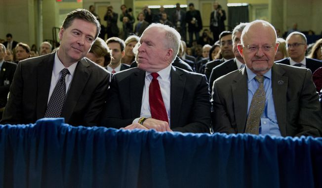From left, FBI Director James Comey, CIA Director John Brennan, and Director of National Intelligence James Clapper sit together in the front row before President Barack Obama spoke about National Security Agency (NSA) surveillance, Friday, Jan. 17, 2014, at the Justice Department in Washington. The president called for ending the government&#x27;s control of phone data from millions of Americans. (AP Photo/Carolyn Kaster)