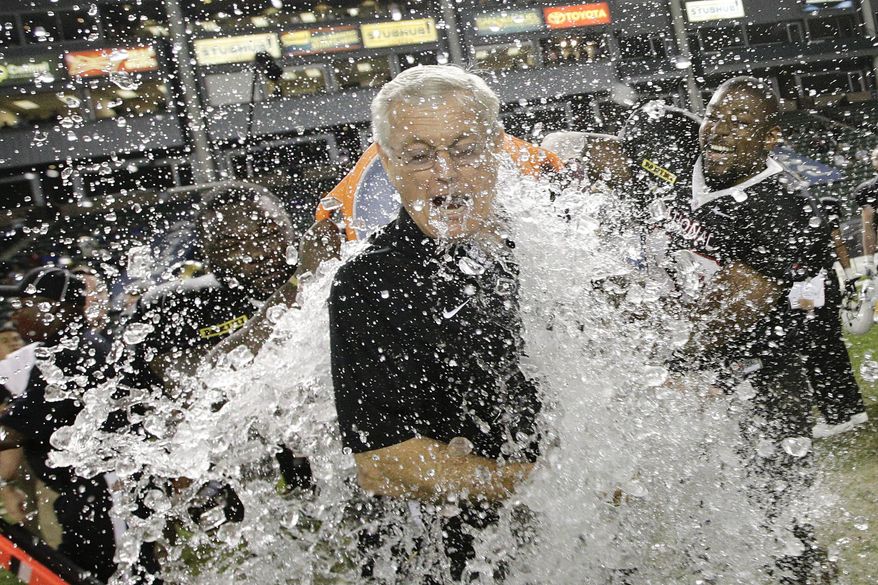 National team fullbacks J.C. Copeland, left, of LSU, and Ray Agnew, right, of Southern Illinois, dump water on coach Dick Vermeil as they celebrate the team's 31-17 win against the American team in the NFLPA Collegiate Bowl football game Saturday, Jan. 18, 2014, in Carson, Calif. (AP Photo/Jae C. Hong)