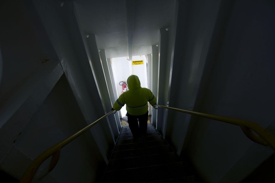 A crew member descends to the first deck as the Cape May-Lewes Ferry approaches in Cape May, N.J. on Jan. 8, 2014. For a half-century, the ferry has beaten “driving around” virtually every day, stopping only for ice, hurricanes and an employee strike back in 1964. Going into its 50th year of operation, the ferry is up against declining ridership, but Heath Gehrke, director of ferry operations for the Delaware River and Bay Authority, hopes to bring back the excitement. (AP Photo/The Daily Times, Joe Lamberti) NO SALES