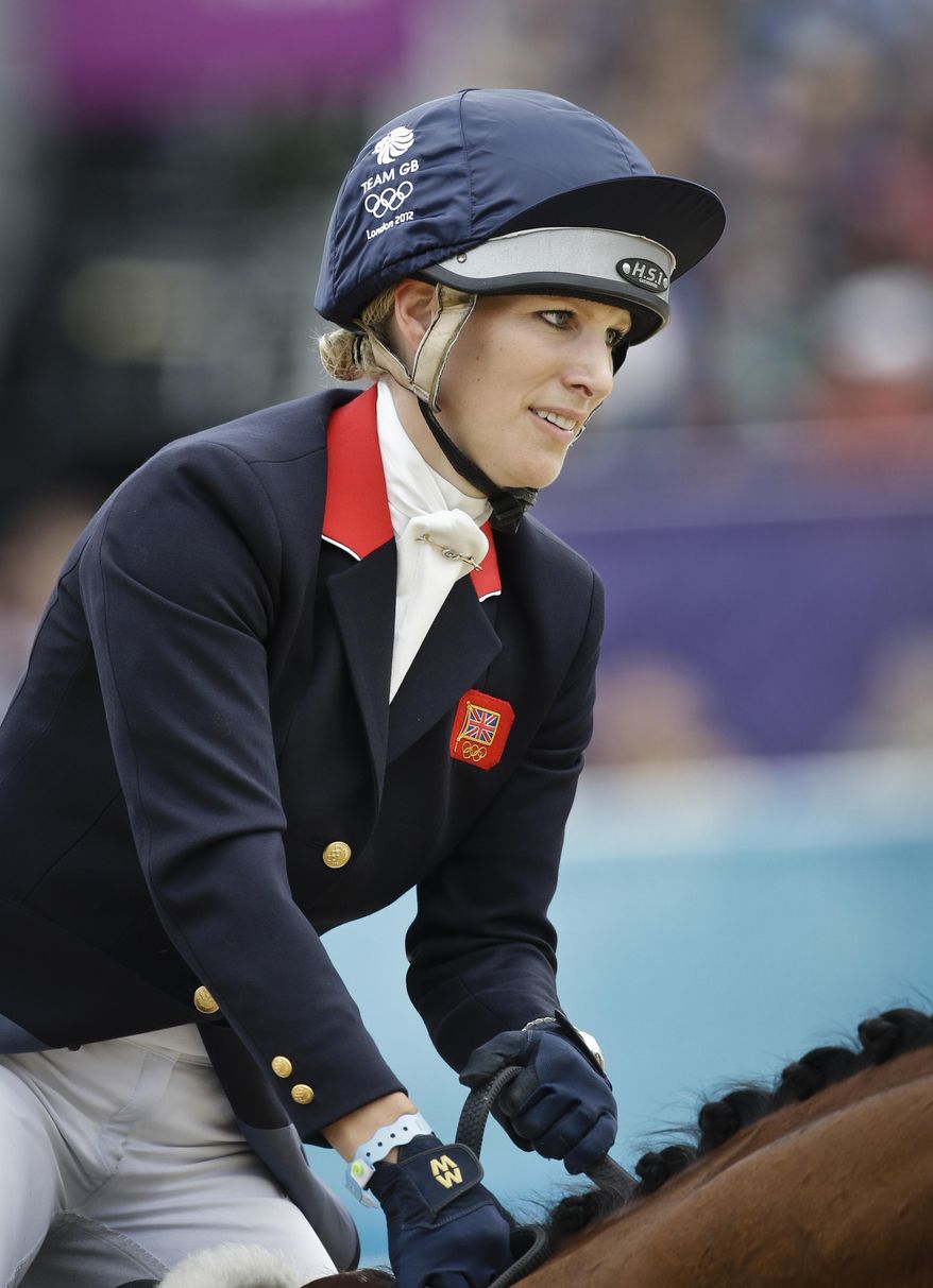 FILE - Britain's Zara Phillips and her horse High Kingdom compete in the show-jumping phase of the equestrian eventing competition at the 2012 Summer Olympics, in this file photo dated Tuesday, July 31, 2012, at Greenwich Park in London. Buckingham Palace announced Friday Jan, 17, 2014, that Queen Elizabeth II's granddaughter Zara Phillips and husband Mike Tindall have given birth to a 7 pounds, 12 ounces (3.5 kilograms) baby girl at Gloucestershire Royal Hospital. (AP Photo/Markus Schreiber, FILE)