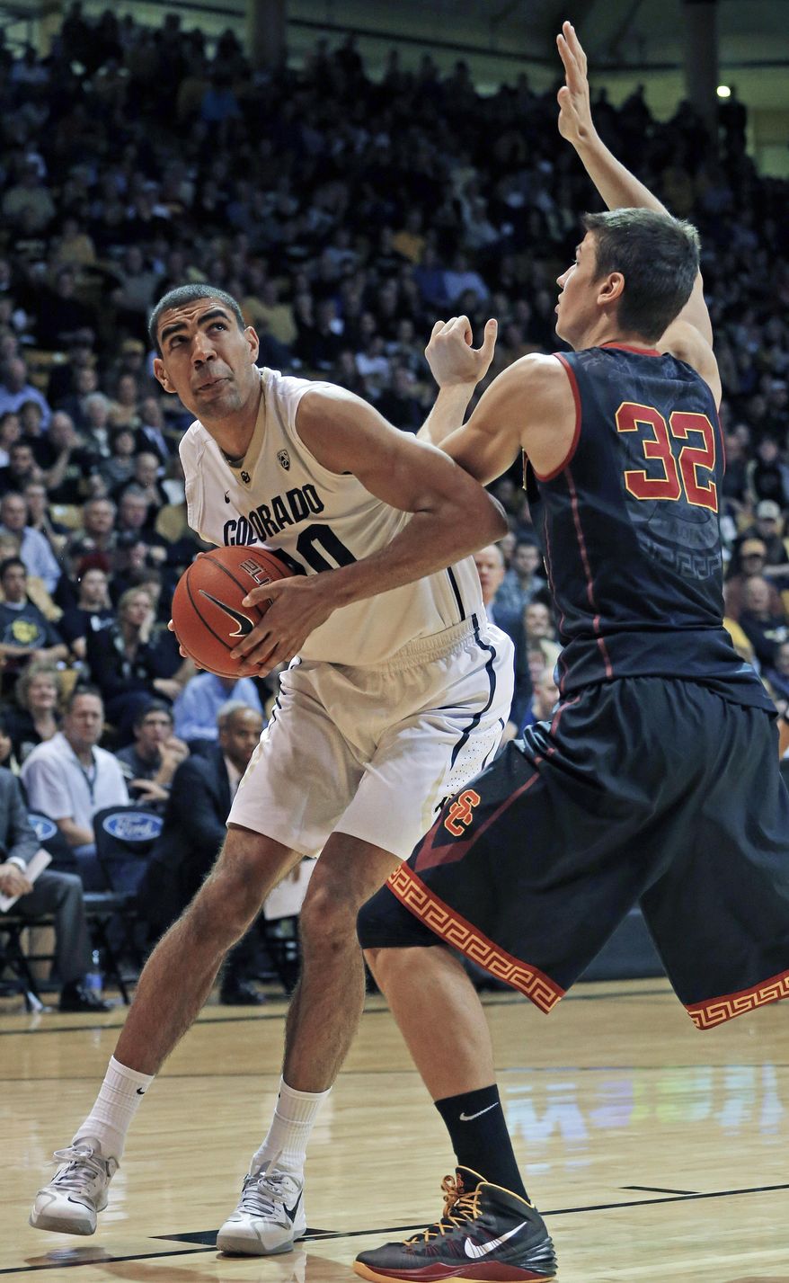 Colorado's Josh Scott looks for a shot as Southern California's Nikola Jovanovic defends during the second half of an NCAA college basketball game in Boulder, Colo., Saturday, Jan. 18, 2014. Colorado won 83-62. (AP Photo/Brennan Linsley)