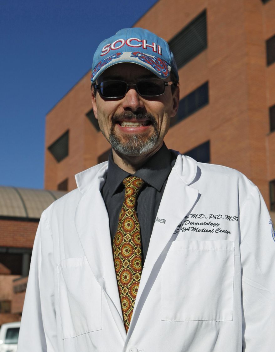 In a Jan. 26, 2012 file photo, Dr. Robert Dellavalle, chief of dermatology at the Denver VA and an associate professor at the University of Colorado's medical school, stands at the VA Medical Center. A Colorado House bill up for its first hearing in February 2014 would ban people younger than 18 from using tanning beds in Colorado without a doctor's prescription. The measure goes further than previous attempts, which sought to require parental permission. Supporters like Dellavalle this year hope a new proposal can break the alliance of skin cancer survivors and the indoor tanning industry. (AP Photo/Ed Andrieski, File)