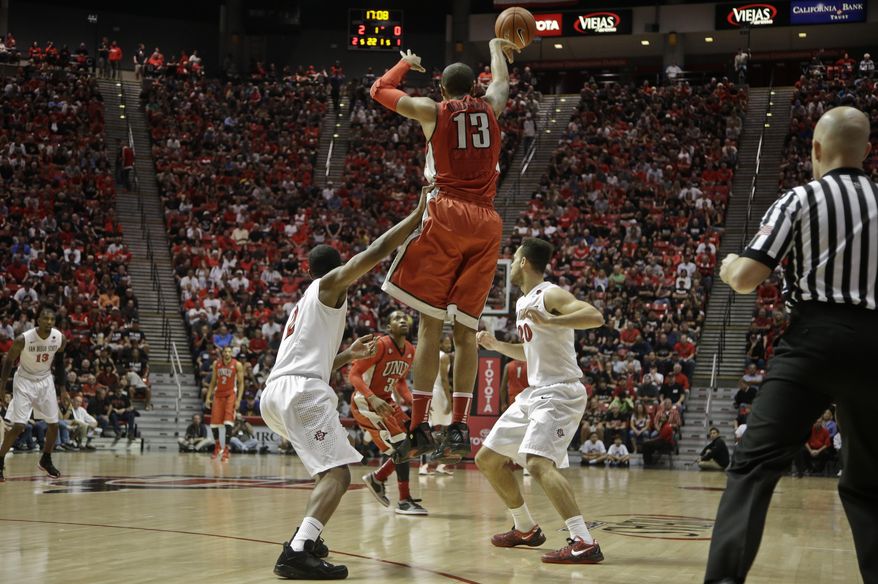 UNLV guard Bryce Dejean-Jones (13) beats the San Diego State press as he passes downcourt during the first half of an NCAA college basketball game on Saturday, Jan. 18, 2014, in San Diego. (AP Photo/Lenny Ignelzi)
