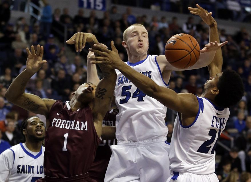 Fordham's Mandell Thomas (1) loses control of the ball on his way to to the basket as Saint Louis' Jordair Jett, left, John Manning and Dwayne Evans, right, defend during the first half of an NCAA college basketball game Saturday, Jan. 18, 2014, in St. Louis. (AP Photo/Jeff Roberson)