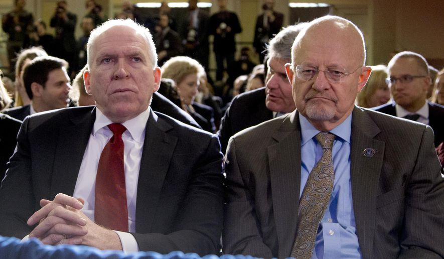 Director of National Intelligence James Clapper, right, and CIA Director John Brennan, left, sit in the front row before President Barack Obama spoke about National Security Agency (NSA) surveillance, Friday, Jan. 17, 2014, at the Justice Department in Washington. (AP Photo/Carolyn Kaster) ** FILE **