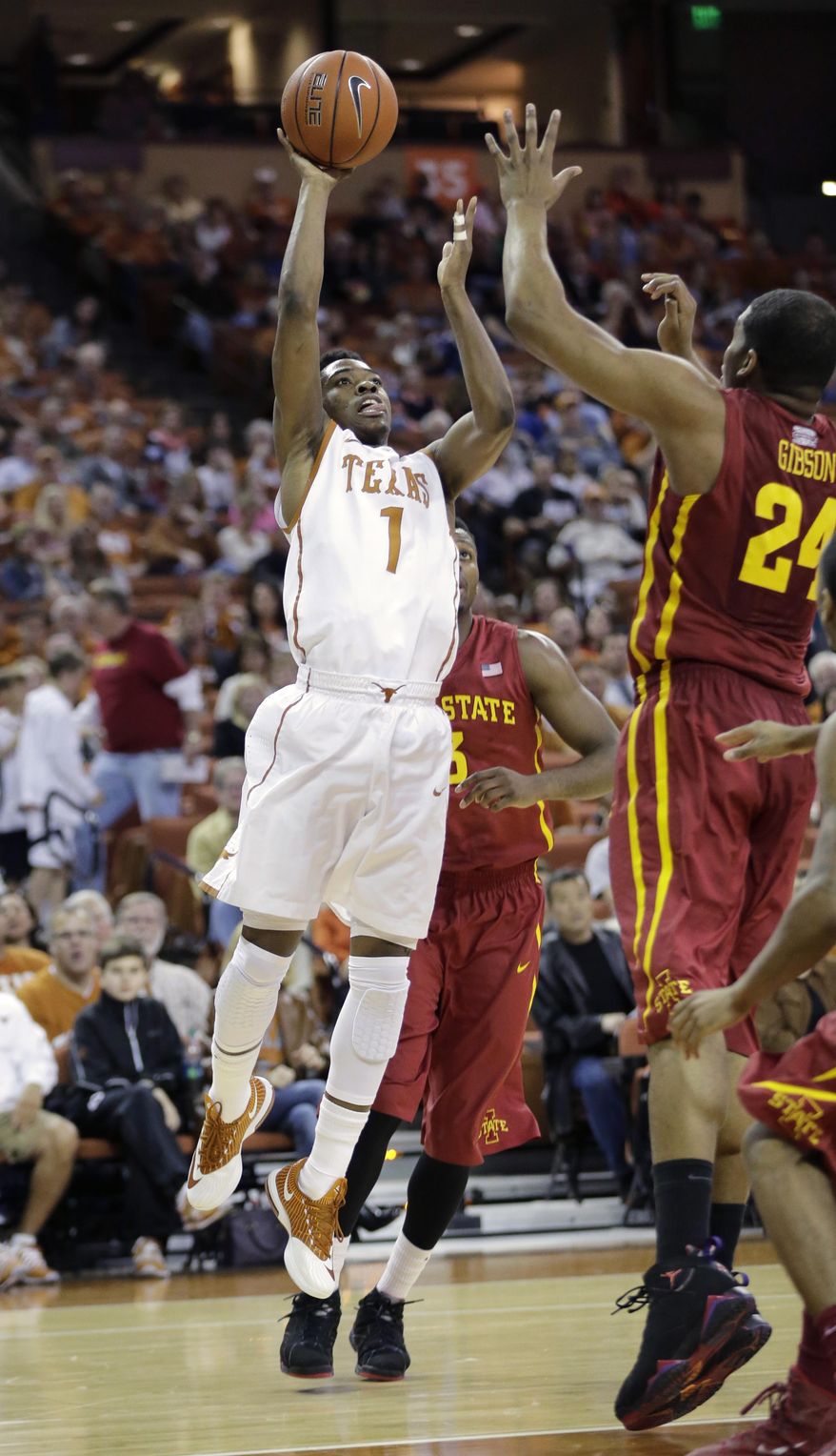 Texas' Isaiah Taylor (1) shoots over Iowa State's Percy Gibson (24) during the first half on an NCAA college basketball game, Saturday, Jan. 18, 2014, in Austin, Texas. (AP Photo/Eric Gay)