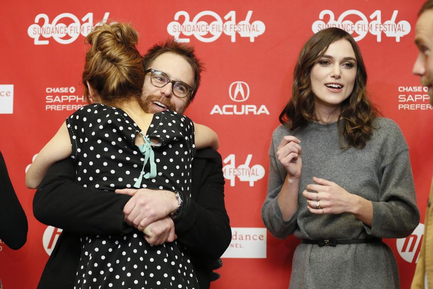 Actor Sam Rockwell hugs fellow cast member Chloe Grace Moretz, as Keira Knightley, right, stands with them at the premiere of the film "Laggies" during the 2014 Sundance Film Festival, on Friday, Jan. 17, 2014, in Park City, Utah. (Photo by Danny Moloshok/Invision/AP)