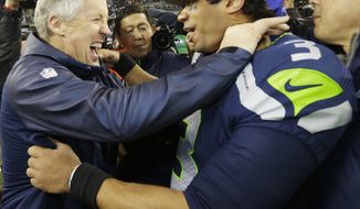 Seattle Seahawks head coach Pete Carroll celebrates with Seattle Seahawks&#39; Russell Wilson after the second half of the NFL football NFC Championship game against the San Francisco 49ers Sunday, Jan. 19, 2014, in Seattle. The Seahawks won 23-17 to advance to Super Bowl XLVIII. (AP Photo/Ted S. Warren) 