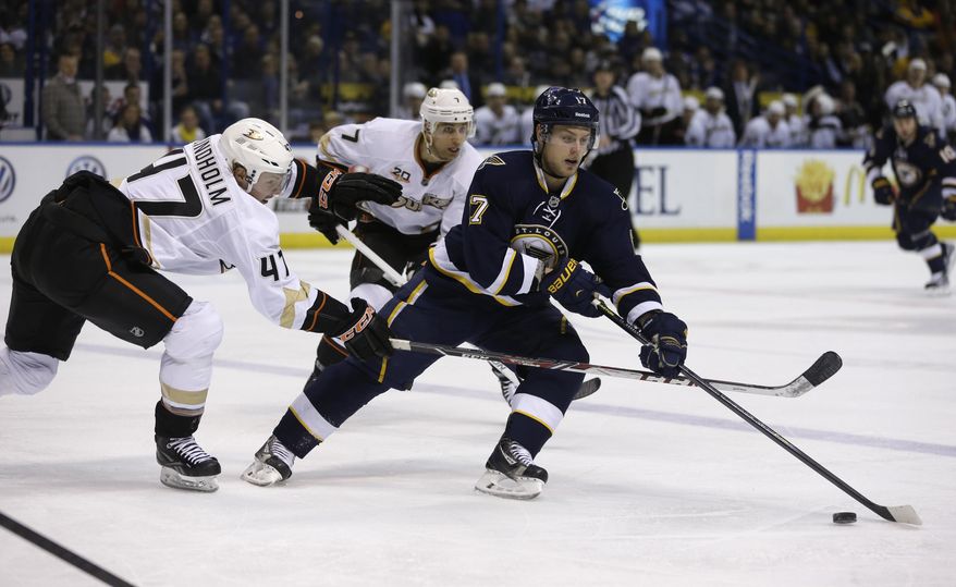 St. Louis Blues' Vladimir Sobotka, right, of the Czech Republic, controls the puck as Anaheim Ducks' Hampus Lindholm, left, of Sweden, and Andrew Cogliano, center, give chase during the second period of an NHL hockey game on Saturday, Jan. 18, 2014, in St. Louis. (AP Photo/Jeff Roberson)