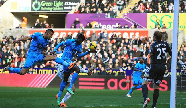 Tottenham Hotspur&#x27;s Emmanuel Adebayor, centre, prior to scoring his team&#x27;s opening goal, during the English Premier League soccer match against Swansea City,  at the Liberty Stadium, Swansea, Wales, Sunday Jan. 19, 2014. (AP Photo/PA, Nick Potts) UNITED KINGDOM OUT