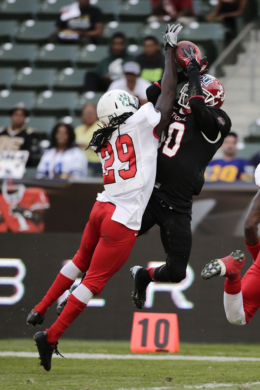 National team wide receiver Isaiah Burse, right, of Fresno State, makes a catch against American team defensive back Brian Dixon, of Northwest Missouri State, during the first half of the NFLPA Collegiate Bowl football game on Saturday, Jan. 18, 2014, in Carson, Calif. (AP Photo/Jae C. Hong)