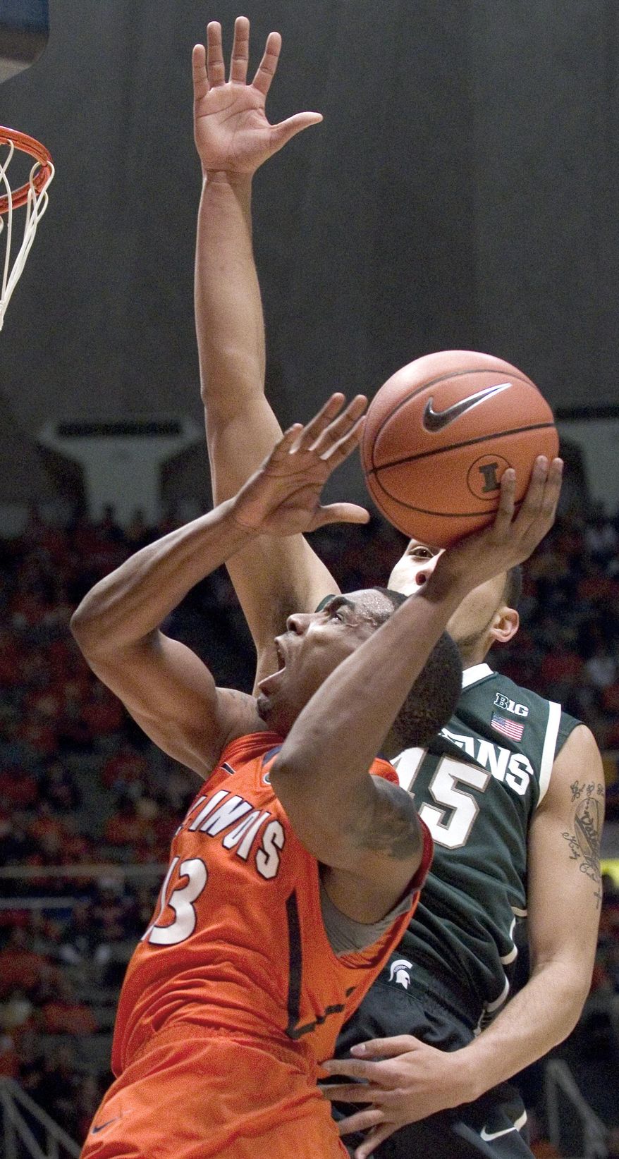 Illinois' Tracy Abrams (13) looks for a shot against Michigan State's Denzel Valentine (45) during an NCAA college basketball game in Champaign, Ill., on Saturday, Jan. 18, 2014. (AP Photo/Robin Scholz)