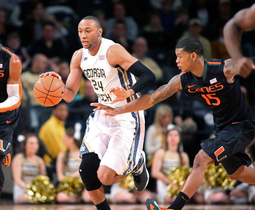 Georgia Tech forward Kammeon Holsey (24) dribbles up the court as Miami guard Rion Brown, right, defends in the second half of an NCAA college basketball game, Saturday, Jan. 18, 2014, in Atlanta. Miami defeated Georgia Tech 56-42. Holsey had 8 pts for Georgia Tech, while Brown had 12 pts for Miami. (AP Photo/Jason Getz)