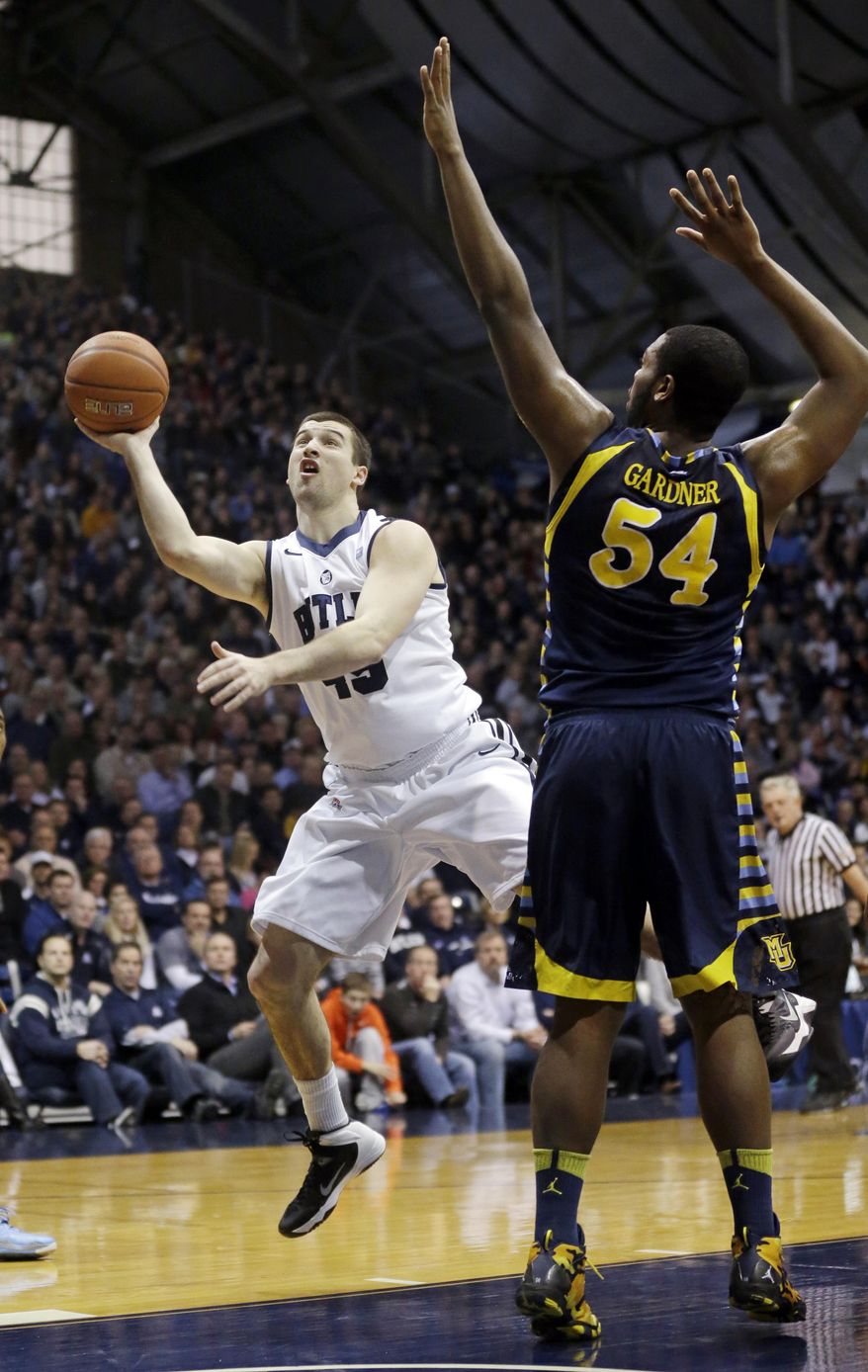 Butler forward Andrew Chrabascz, left, shoots under Davante Gardner in the first half of an NCAA college basketball game in Indianapolis, Saturday, Jan. 18, 2014. (AP Photo/Michael Conroy)