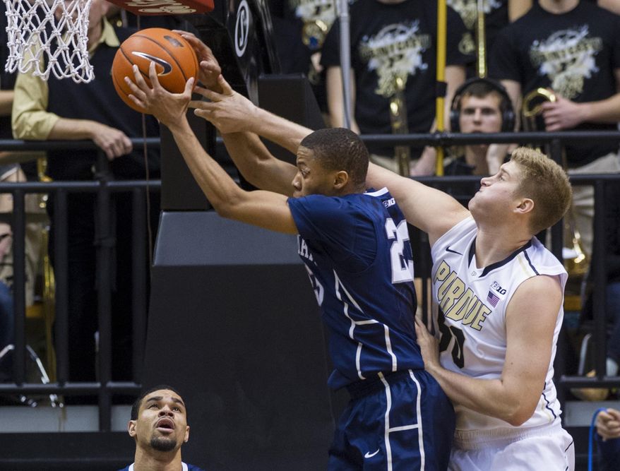 Purdue's Travis Carroll (50) fouls Penn State's Tim Frazier (23) as they compete for a rebound during the first half of an NCAA college basketball game, Saturday, Jan. 18, 2014, in West Lafayette, Ind. (AP Photo/Doug McSchooler)