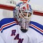 New York Rangers goaltender Cam Talbot (33) stops the puck under his facemask during the second period of an NHL hockey game against the Ottawa Senators in Ottawa, Saturday, Jan. 18, 2014. (AP Photo/The Canadian Press, Fred Chartrand)