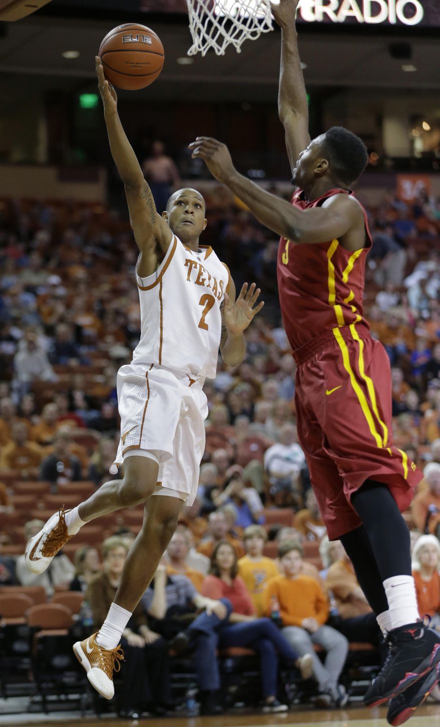 Texas' Demarcus Holland (2) shoots over Iowa State's Melvin Ejim, right, during the first half on an NCAA college basketball game, Saturday, Jan. 18, 2014, in Austin, Texas. (AP Photo/Eric Gay)