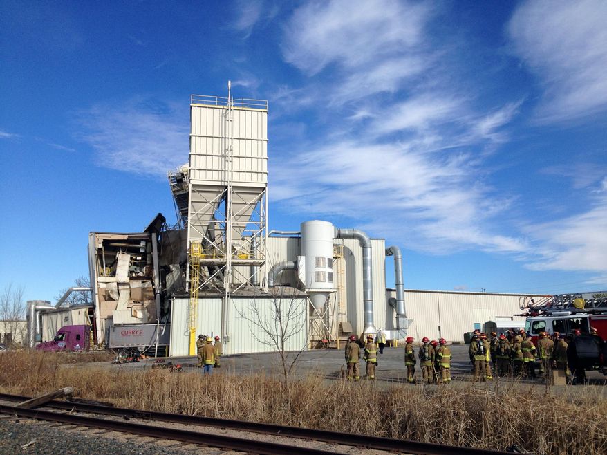 Firefighters stand outside the International Nutrition plant in Omaha, Neb., Monday, where a fire and explosion took place Jan. 20, 2014. At least nine people have been hospitalized and others could be trapped at the animal feed processing plant. (AP Photo/Nati Harnik)