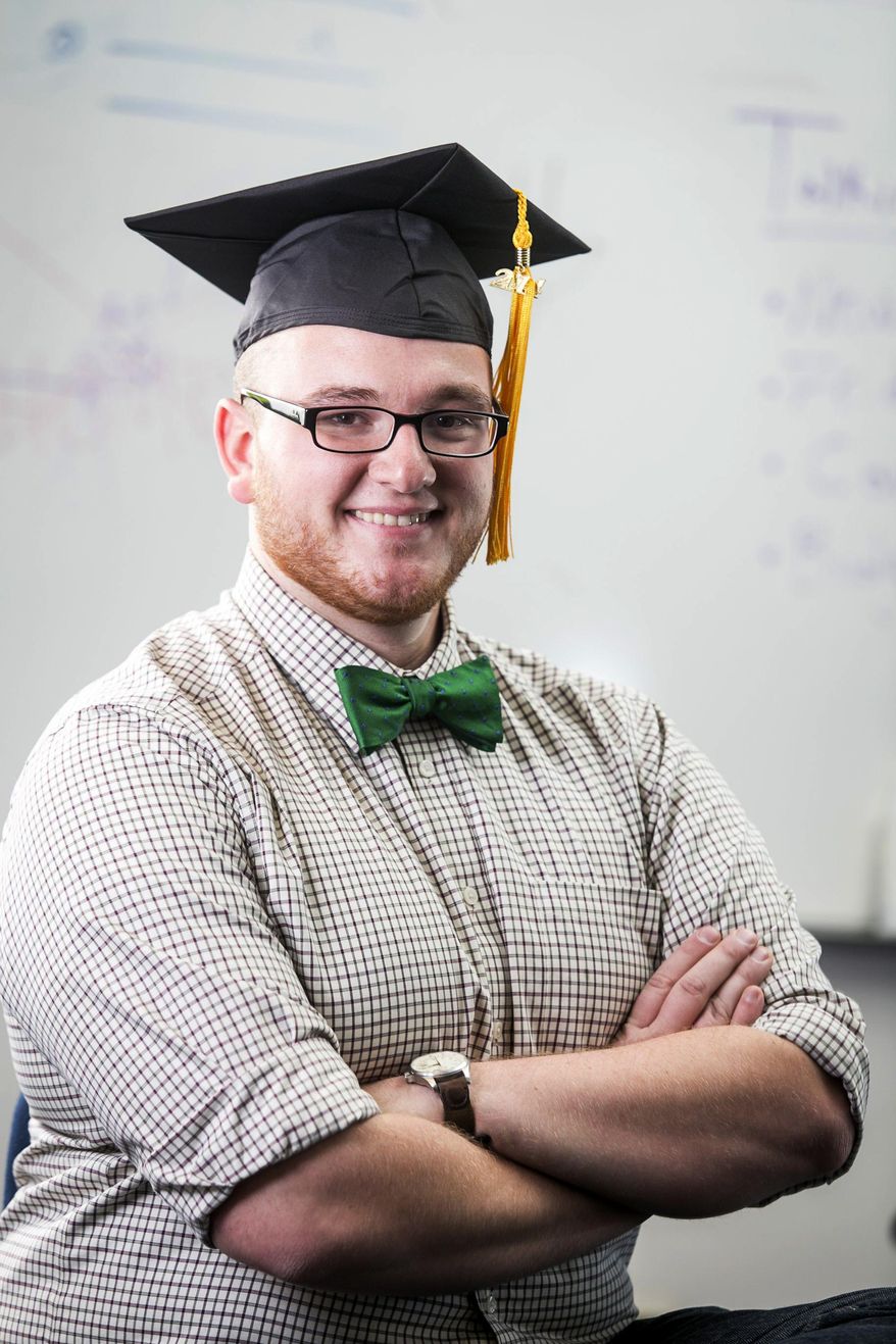 Alex Benda, 22, poses in a gaduation cap at the Michigan Times offices at the University of Michigan-Flint in Flint, Mich. on Friday, Jan. 17, 2014. Bends says he hopes to sell add space on his graduation cap to take a bite out of his education debt. (AP Photo/The Detroit Free Press, Jarrad Henderson) DETROIT NEWS OUT, TV OUT, INTERNET OUT, MAGS OUT, NO SALES, MANDATORY CREDIT DETROIT FREE PRESS