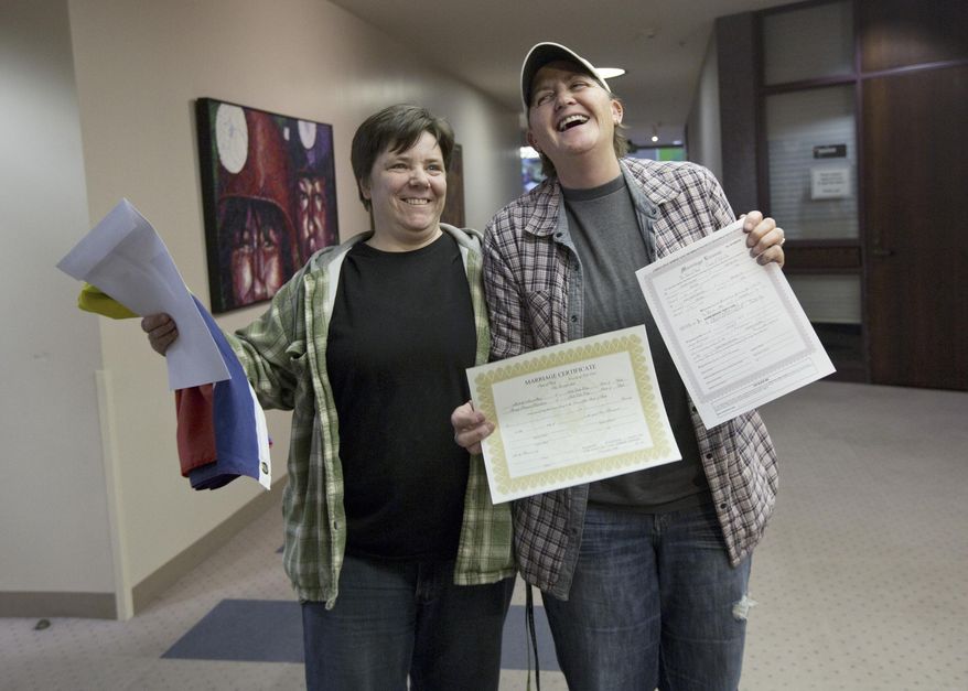 FILE - This Dec. 20, 2013 file photo shows Elise Larsen, left, and Samantha Christensen, right, displaying their marriage license after being one of the first same sex couples to receive one at the Salt Lake County Clerk's Office in Salt Lake City. Hours after federal judges struck down bans on same-sex marriage in Utah and Oklahoma, activist Evan Wolfson and his colleagues reached out to gay rights groups in the deeply conservative states with both congratulations and a reminder: Court wins alone won't be enough. (AP Photo/Kim Raff, file)