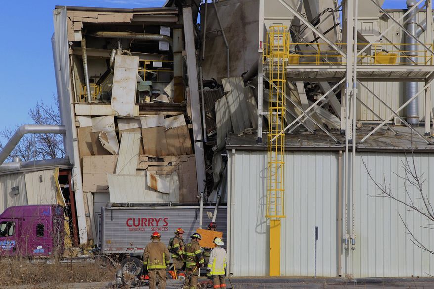 Firefighters stage outside the International Nutrition plant in Omaha, Neb., Monday, where a fire and explosion took place Jan. 20, 2014. At least nine people have been hospitalized and others could be trapped at the animal feed processing plant. (AP Photo/Nati Harnik)