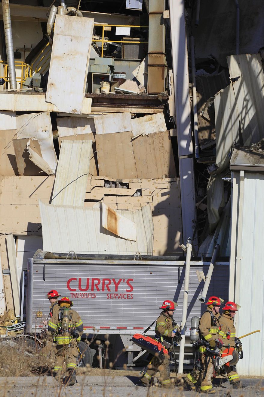 Firefighter stage outside the International Nutrition plant in Omaha, Neb., Monday, where a fire and explosion took place Jan. 20, 2014. At least nine people have been hospitalized and others could be trapped at the animal feed processing plant. (AP Photo/Nati Harnik)
