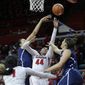 Rutgers forward Betnijah Laney (44) takes a shot as she splits Connecticut defenders Kiah Stokes and Stefanie Dolson, right, during the first half of an NCAA college basketball game Sunday, Jan. 19, 2014, in Piscataway, N.J. (AP Photo/Mel Evans)
