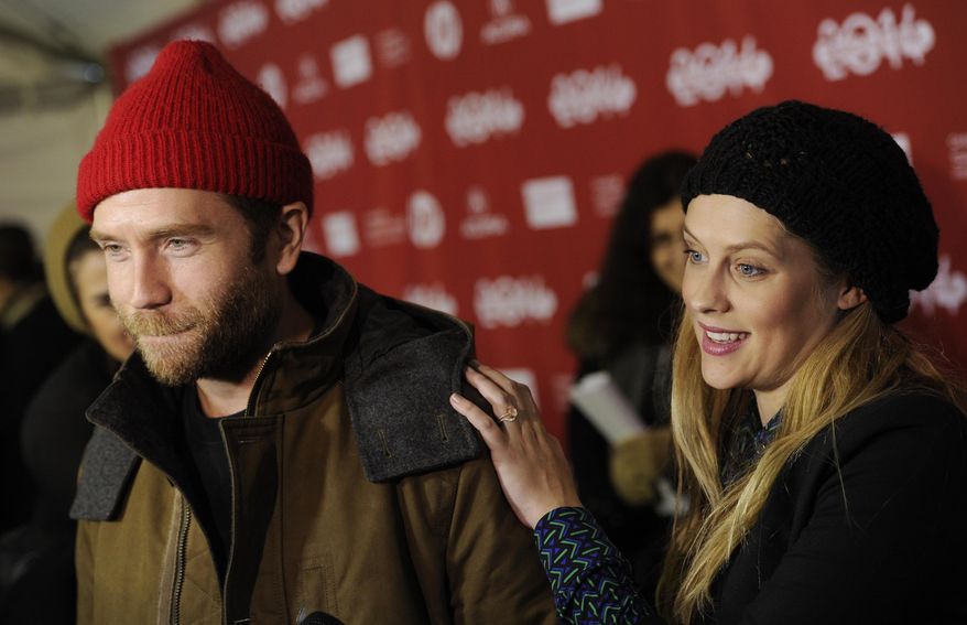 FILE - In this Sunday, Jan. 19, 2014 file photo, Mark Webber, left, a cast member in "Happy Christmas," is joined by his wife, actress Teresa Palmer," as he is interviewed at the premiere of the film at the 2014 Sundance Film Festival, in Park City, Utah. The sweetest couple around Sundance may be Webber and Palmer.  Webber, an actor, director and screenwriter, has two films, "Laggies" and "Happy Christmas," premiering at the festival and wherever he goes, his pregnant wife has happily followed, snapping photos on her camera phone.  (Photo by Chris Pizzello/Invision/AP, File)