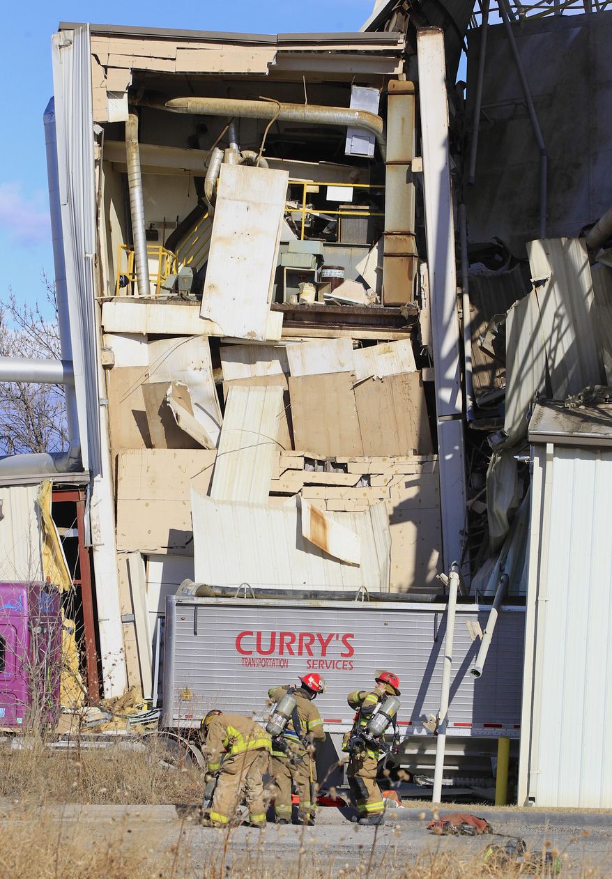 Firefighter stage outside the International Nutrition plant in Omaha, Neb., Monday, where a fire and explosion took place Jan. 20, 2014. At least nine people have been hospitalized and others could be trapped at the animal feed processing plant. (AP Photo/Nati Harnik)