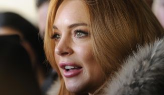 Actress Lindsay Lohan is interviewed following a news conference at the 2014 Sundance Film Festival, Monday, Jan. 20, 2014, in Park City, Utah. (Photo by Chris Pizzello/Invision/AP) ** FILE **