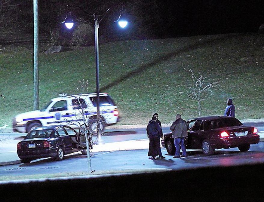 Police investigate a car, left, at the athletic center of Widener University in Chester, Pa. after a student was shot Monday, Jan. 20, 2014. Authorities warned students to remain indoors until further notice. (AP Photo/Delaware County Daily Times, Robert J. Gurecki) PHILLY METRO OUT