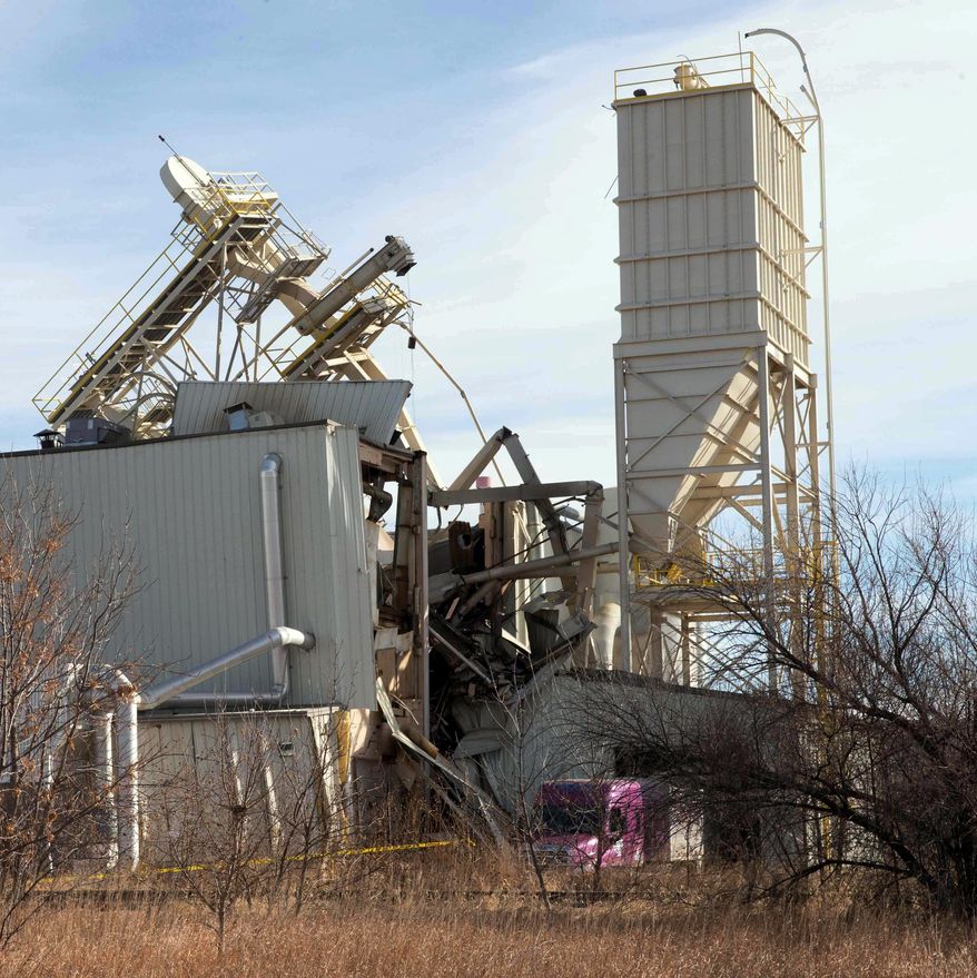Part of the International Nutrition plant in Omaha Neb., is collapsed Monday Jan. 20, 2014 in Omaha Neb. At least nine people have been hospitalized and others could be trapped after an explosion and partial building collapse at an Omaha animal feed processing plant. (AP Photo/The Omaha World-Herald/Jim Burnett) MAGS OUT TV OUT