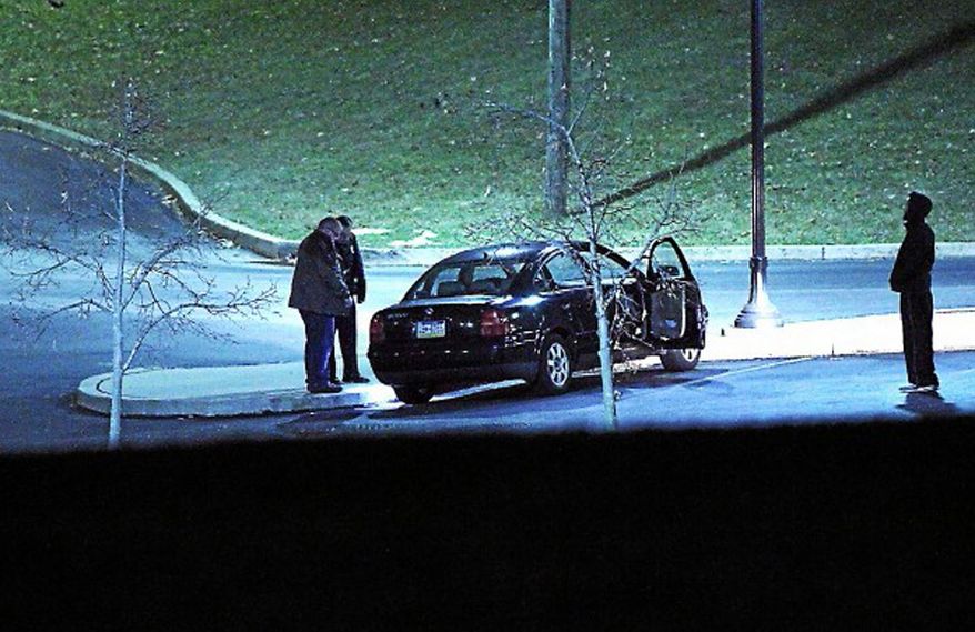 Police investigate a car, left, at the athletic center of Widener University in Chester, Pa. after a student was shot Monday, Jan. 20, 2014. Authorities warned students to remain indoors until further notice. (AP Photo/Delaware County Daily Times, Robert J. Gurecki) PHILLY METRO OUT