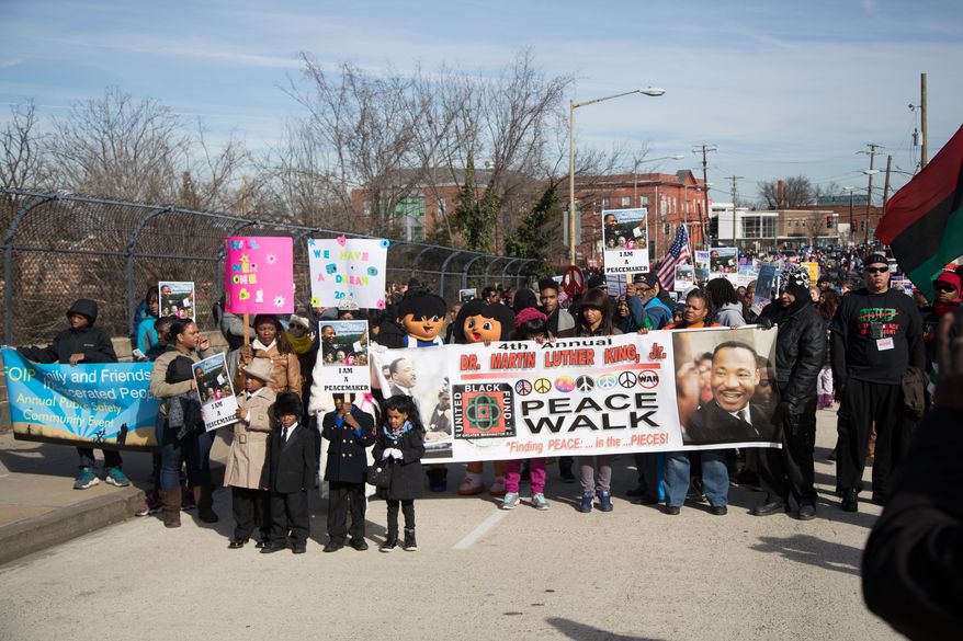 Hundreds of local residents march up MLK Jr. Avenue to participate in the eighth annual MLK Peace Walk commemorating the Rev. Martin Luther King Jr. holiday, in Washington, DC., Monday, January 20, 2014. (Andrew S Geraci/The Washington Times)