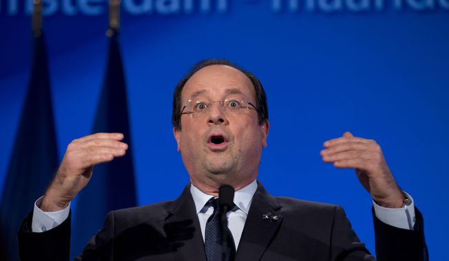 French President Francois Hollande raises his hands during a speech at the National Maritime Museum in Amsterdam, Netherlands, Monday, Jan. 20, 2014. (AP Photo/Peter Dejong) 