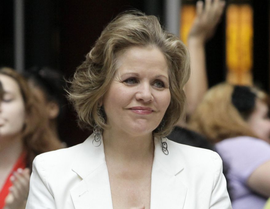 FILE - This March 19, 2012 file photo shows opera singer Renee Fleming in the rotunda of the State of Illinois building, the James R. Thompson Center, in Chicago. Fleming, a four-time Grammy winner, will perform sing the national anthem before the Denver Broncos take on the Seattle Seahawks at MetLife Stadium in East Rutherford, N.J. on Feb 2. (AP Photo/Kiichiro Sato)