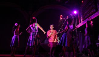 This undated theater image released by The Public Theater shows Ruthie Ann Miles, center, during a performance of &amp;quot;Here Lies Love,&amp;quot; in New York. (AP Photo/The Public Theater, Joan Marcus)