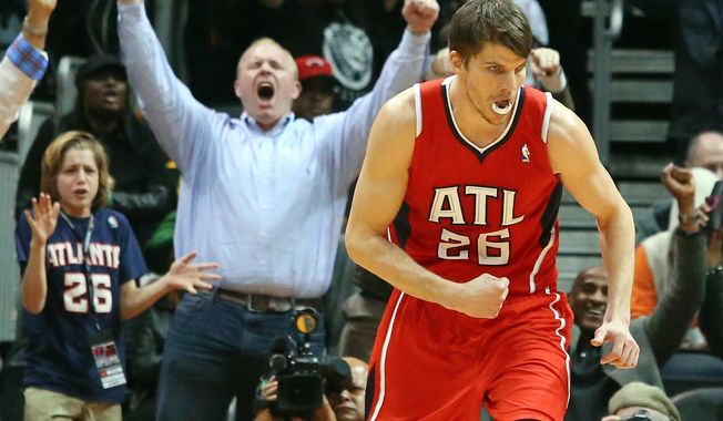 Atlanta Hawks guard Kyle Korver (26) celebrates his 3-pointer that put the Hawks in the lead over the Miami Heat during the second half of an NBA basketball game on Monday, Jan. 20, 2014, in Atlanta. (AP Photo/Atlanta Journal-Constitution, Curtis Compton)