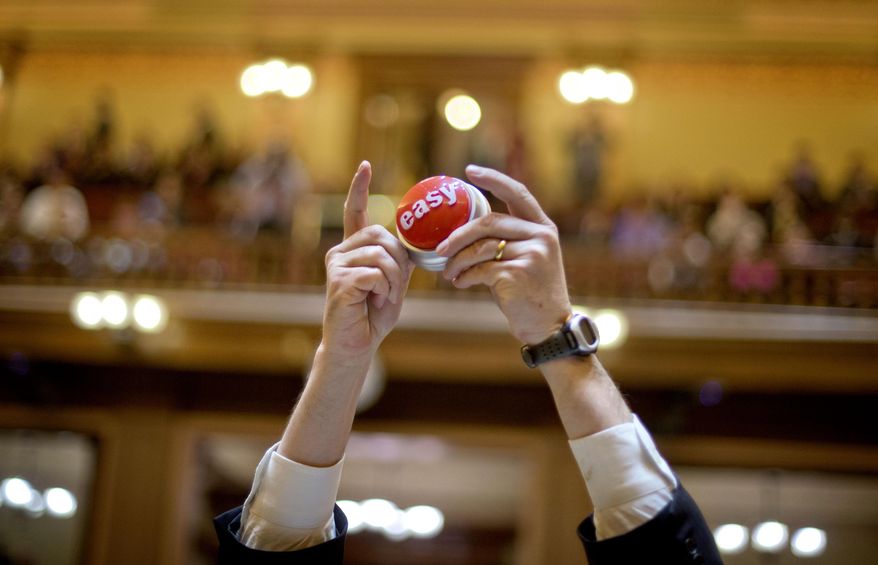 FILE - In this March 28, 2013 file photo, Georgia Rep. Edward Lindsey, R-Atlanta, holds up an easy button as the legislative session comes to a close in the House chamber in Atlanta. Politicians take advantage of the last-minute chaos in Georgia's legislative session, seeking to quietly pass legislation that would invite deep scrutiny if there a chance to debate it. Now state Sen. Joshua McKoon, R-Columbus, wants to end last-minute surprises by requiring that lawmakers get at least 24 hours before voting on a bill. (AP Photo/David Goldman, File)