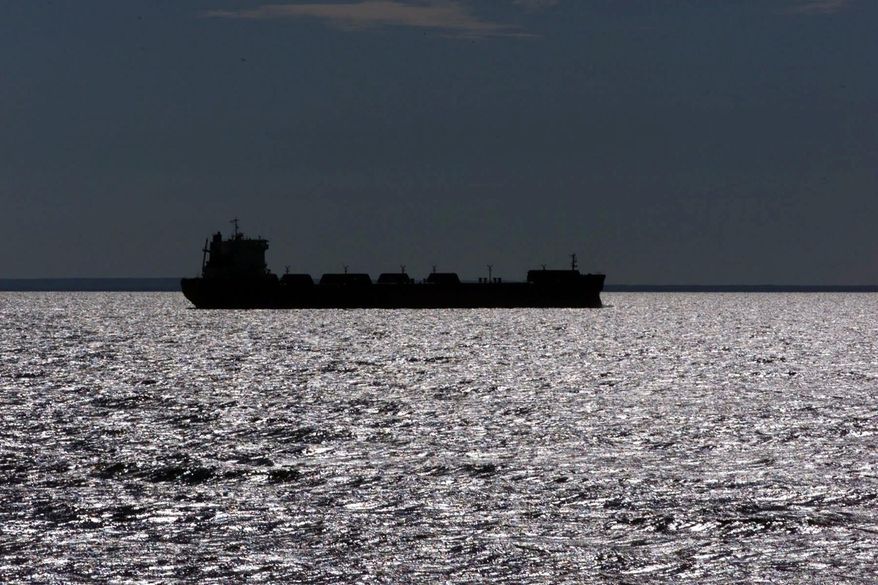 FILE - In this July, 17, 1999, file photo, a freighter is silhouetted on Lake Superior near Whitefish Point, Mich. Two newly completed scientific papers are providing fresh information about how complex interactions of evaporation, precipitation and winter ice cover affect water levels on the Great Lakes, and regional industries such as shipping and tourism. (AP Photo/Carlos Osorio, File)