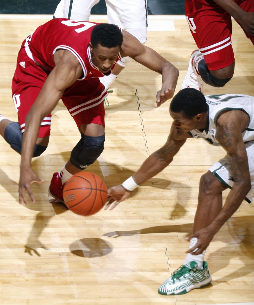 Michigan State's Keith Appling, right, and Indiana's Troy Williams (5) vie for a loose ball during the first half of an NCAA college basketball game, Tuesday, Jan. 21, 2014, in East Lansing, Mich. (AP Photo/Al Goldis)