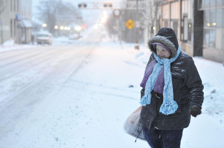 Susan Miller of Windber, Pa. walks during the snow storm on Tuesday, Jan. 21, 2014. The National Weather Service said the storm could bring 8 to 12 inches of snow to Philadelphia and New York City, and more than a foot in Boston. (AP Photo/The Tribune-Democrat, Todd Berkey) THE MORNING CALL OUT; DAILY AMERICAN OUT; WJAC-TV OUT